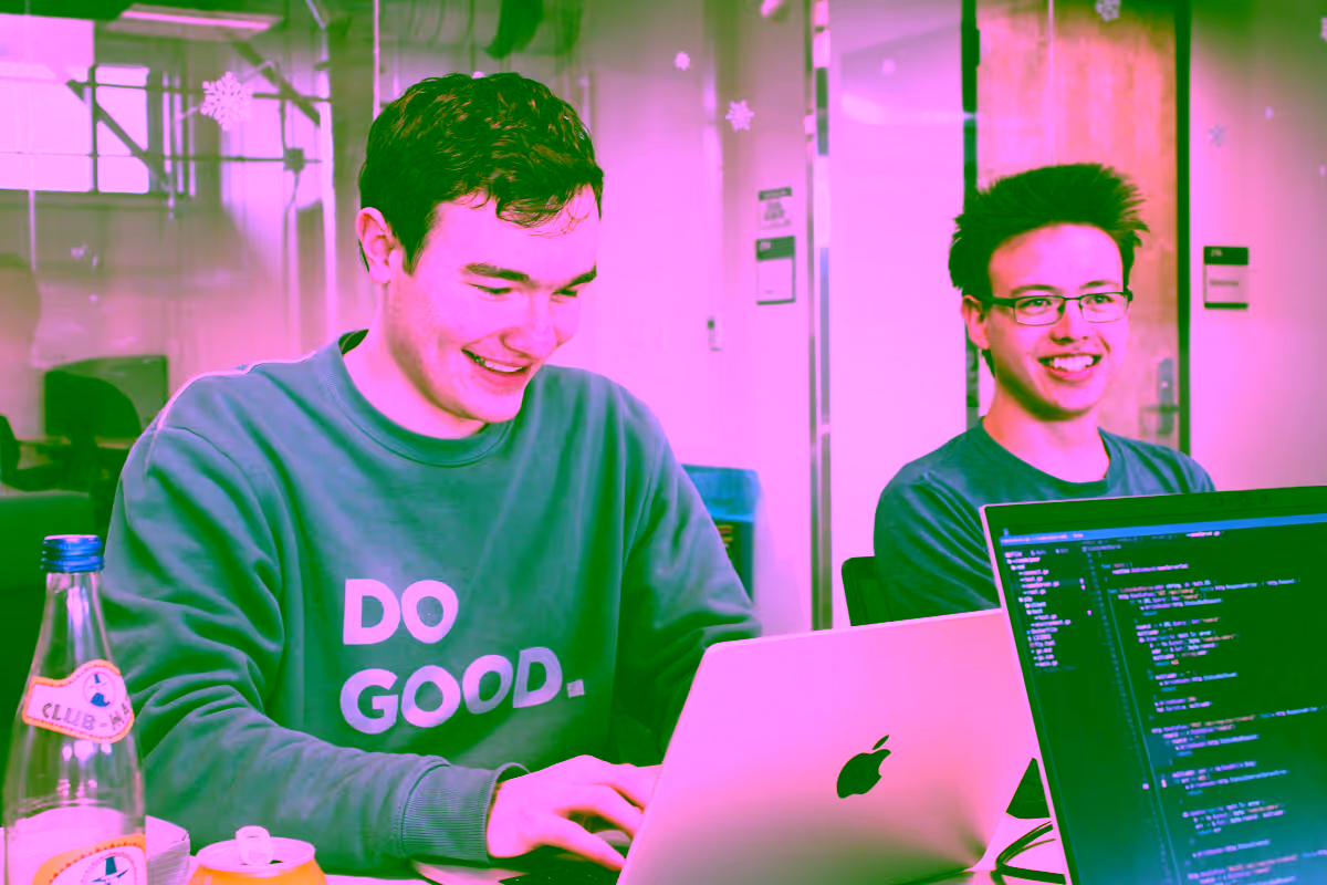Lukas and I work on our laptops in a nice campus building. We are both smiling.